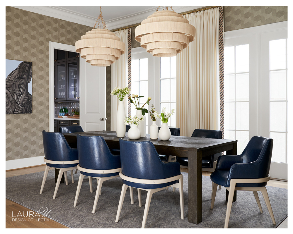 Dining room featuring Phillip Jeffries Vinyl Woven Sisal wallpaper in Ecru Way, a dark wood dining table, blue upholstered dining chairs, woven pendant lights, floor-to-ceiling drapery, and contemporary artwork.