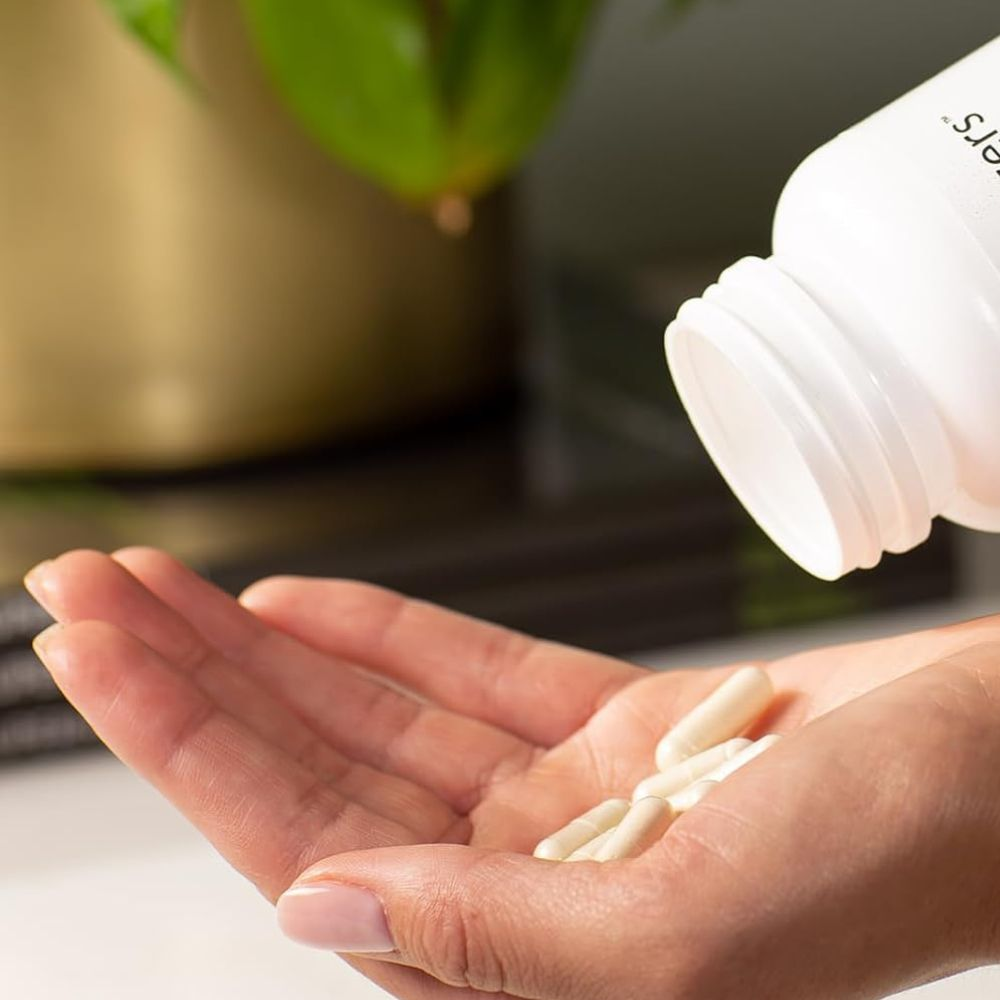 A person holding a bottle of magnesium supplement with a label that reads "Magnesium Supplement"