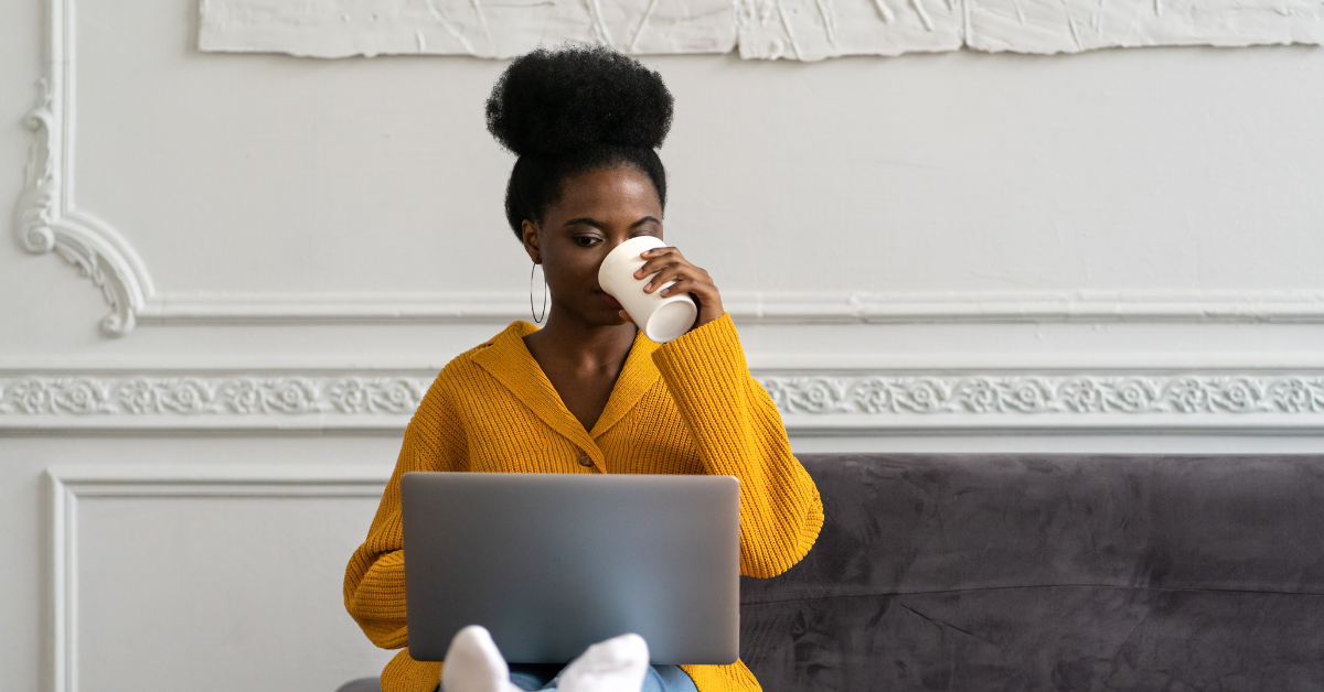 A woman drinking coffee reading about What is the tax form for Onlyfans?