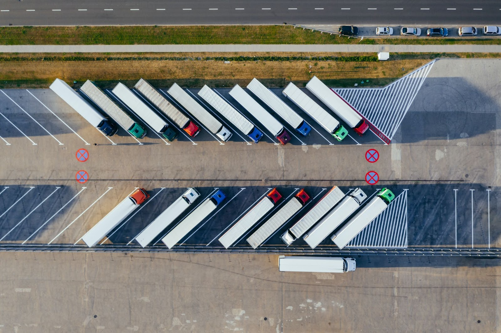 Aerial view of semi-trucks in a large parking lot