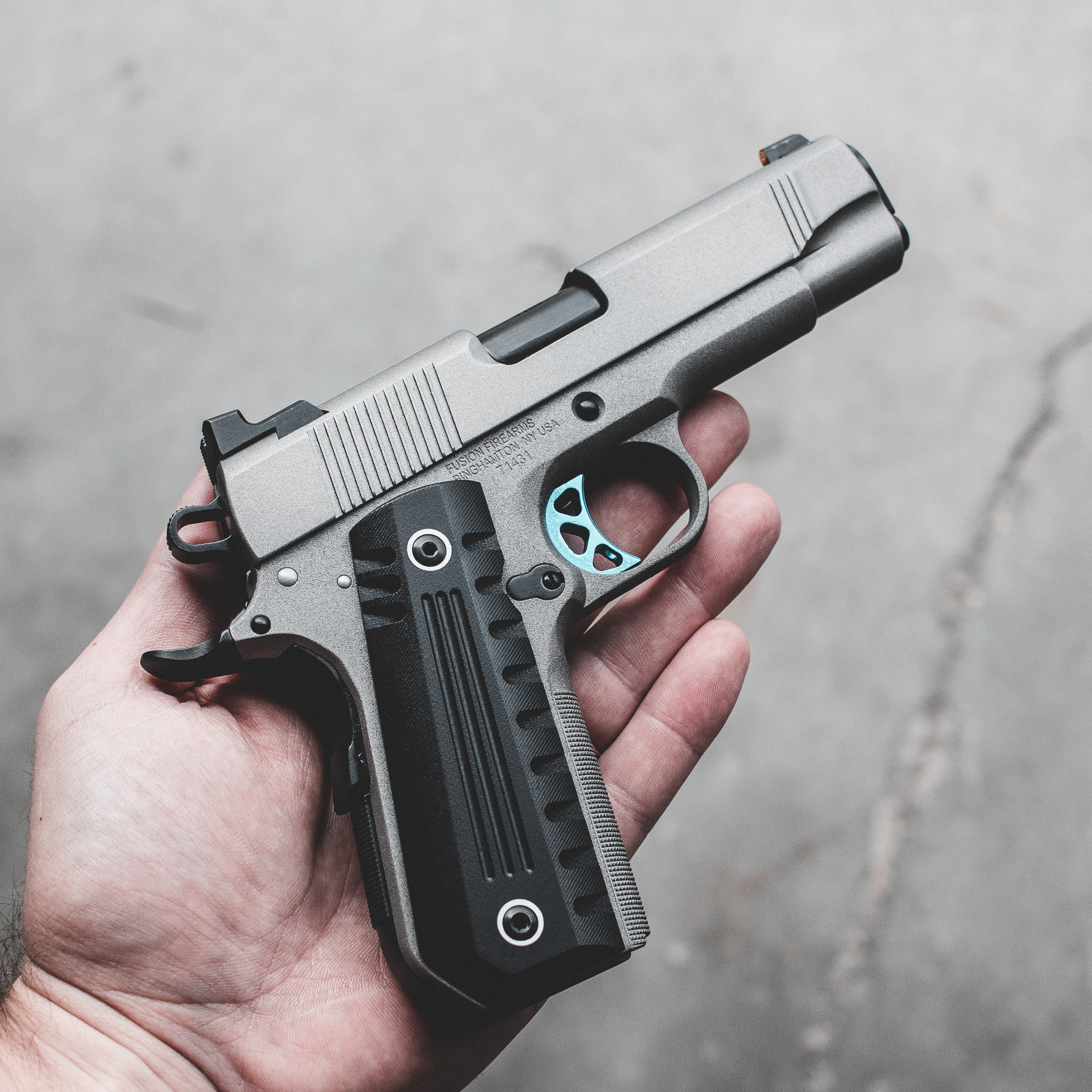 An illustration of a 1911 pistol being held in a defensive stance