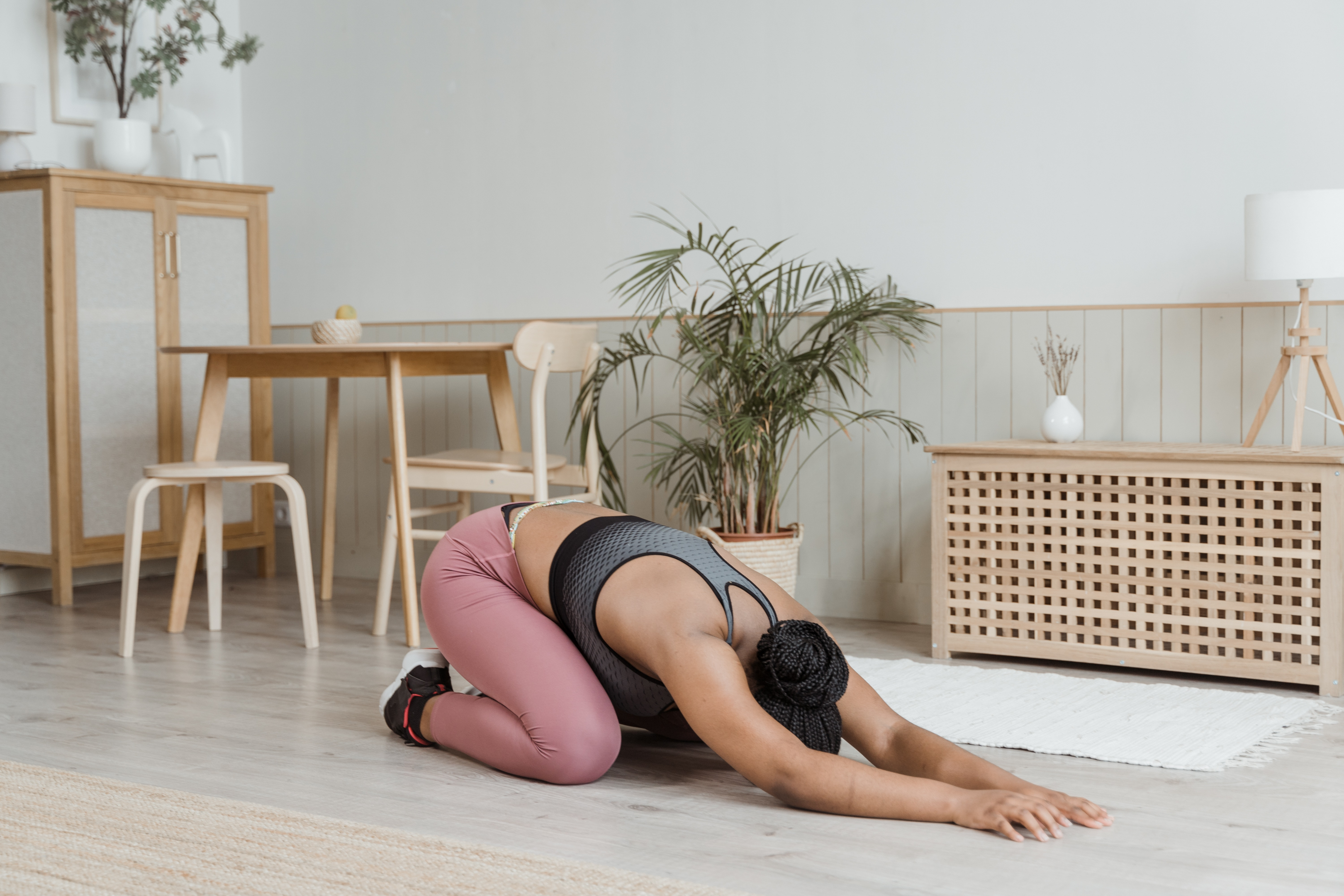 Lady stretching on floor in her home 