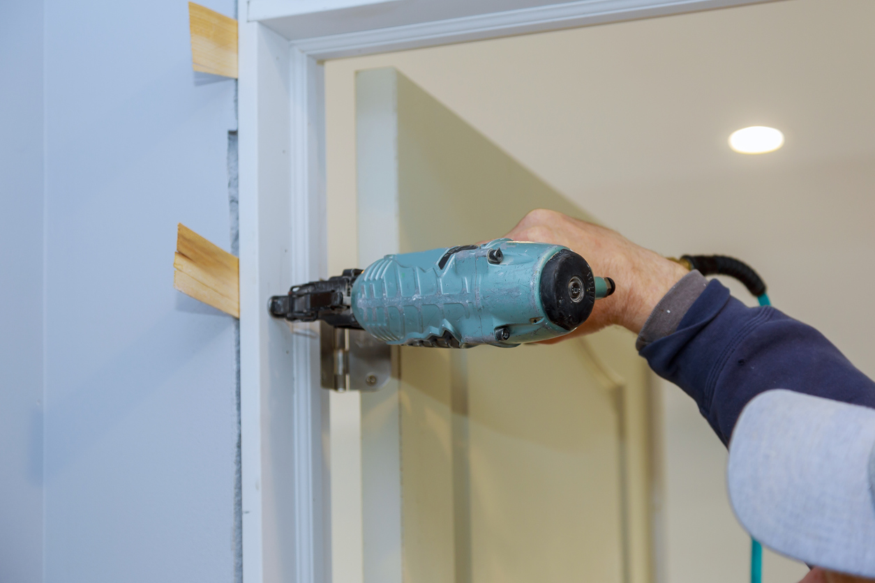 close up of someone using a drill to secure the door frame