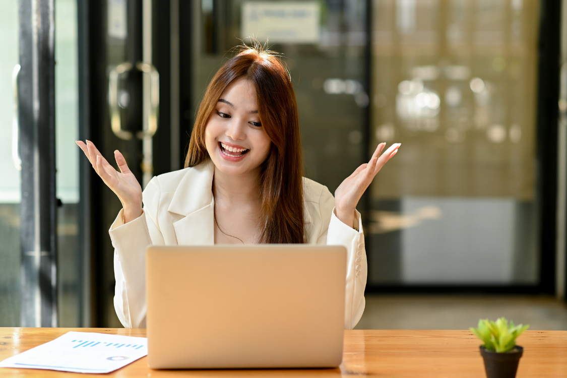 Smiling Filipina applicant participating in a virtual job assessment interview via laptop