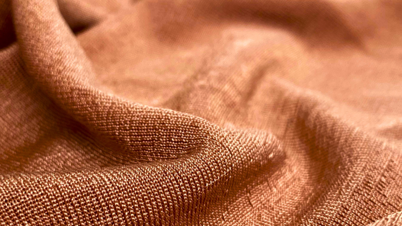 A close up image of a brown colored lyocell fabric