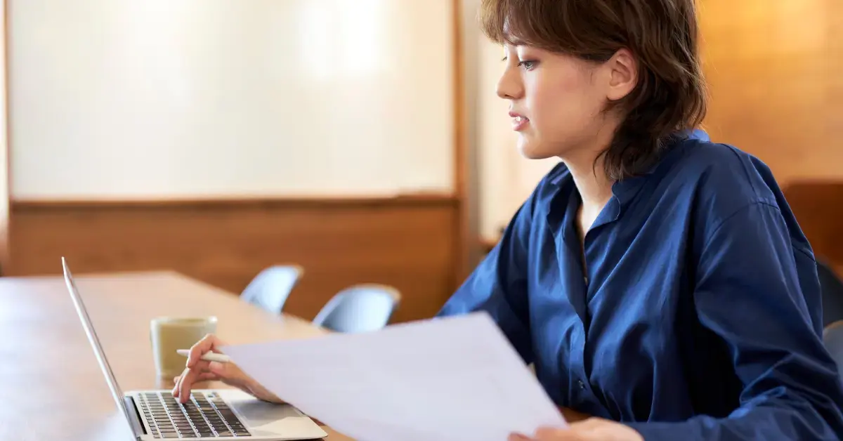 Woman reviewing an IRS notice and letter to IRS template while preparing a clear tax response.