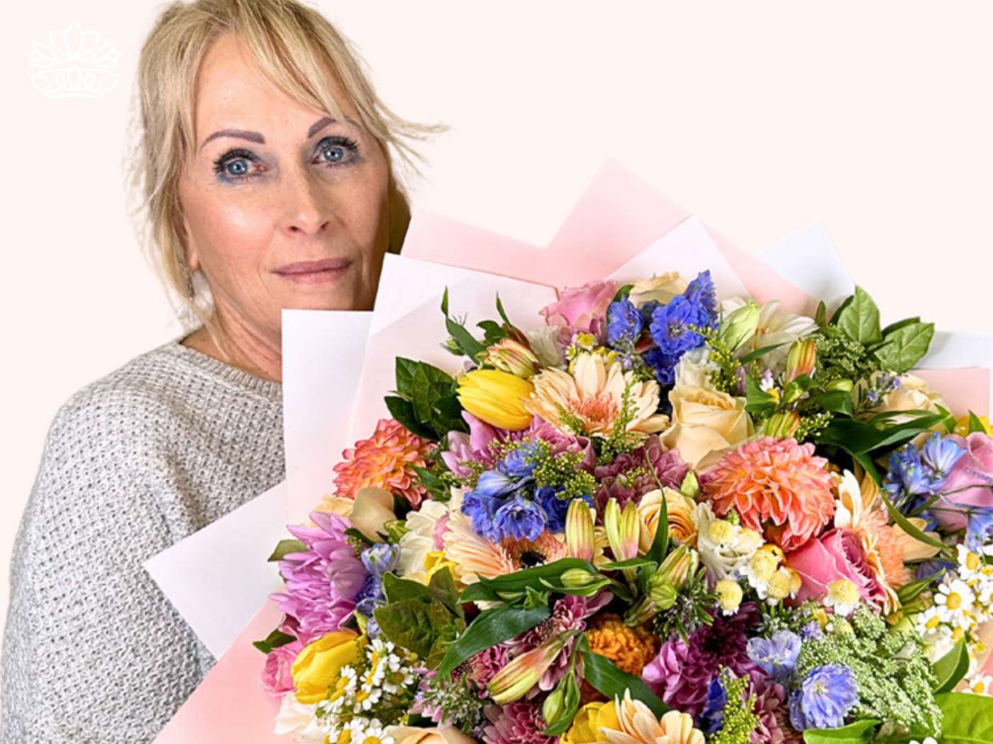 Woman holding a large, colorful bouquet from the Easter Flowers Collection, symbolizing the joy of the Easter celebration and the Christian holiday, presented by Fabulous Flowers and Gifts.