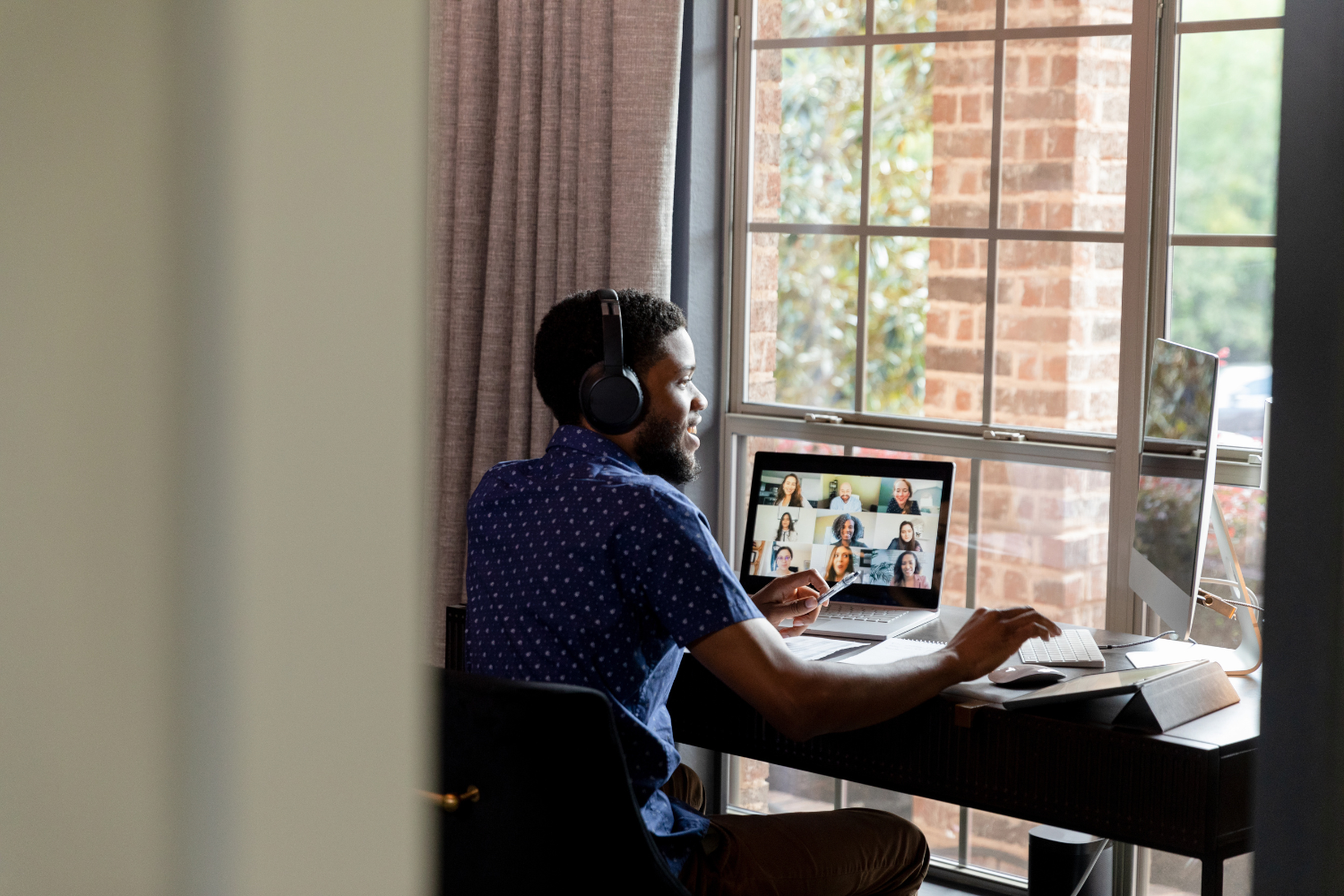 A team leader hosting a virtual check-in with remote workers.