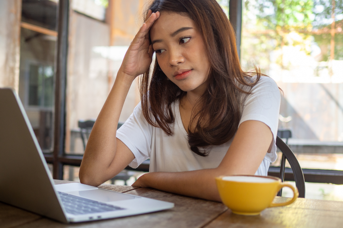 Filipino woman looking frustrated while facing internet issues during a remote work session