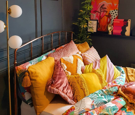 colorful bedding with pillows and fringe