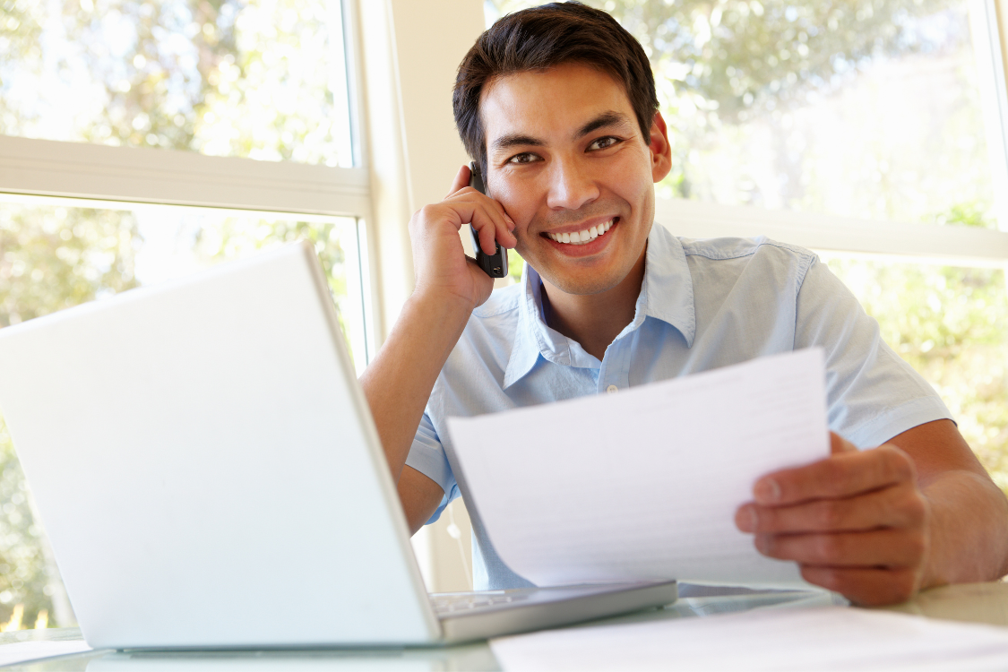 Young Filipino man managing accounting tasks from home