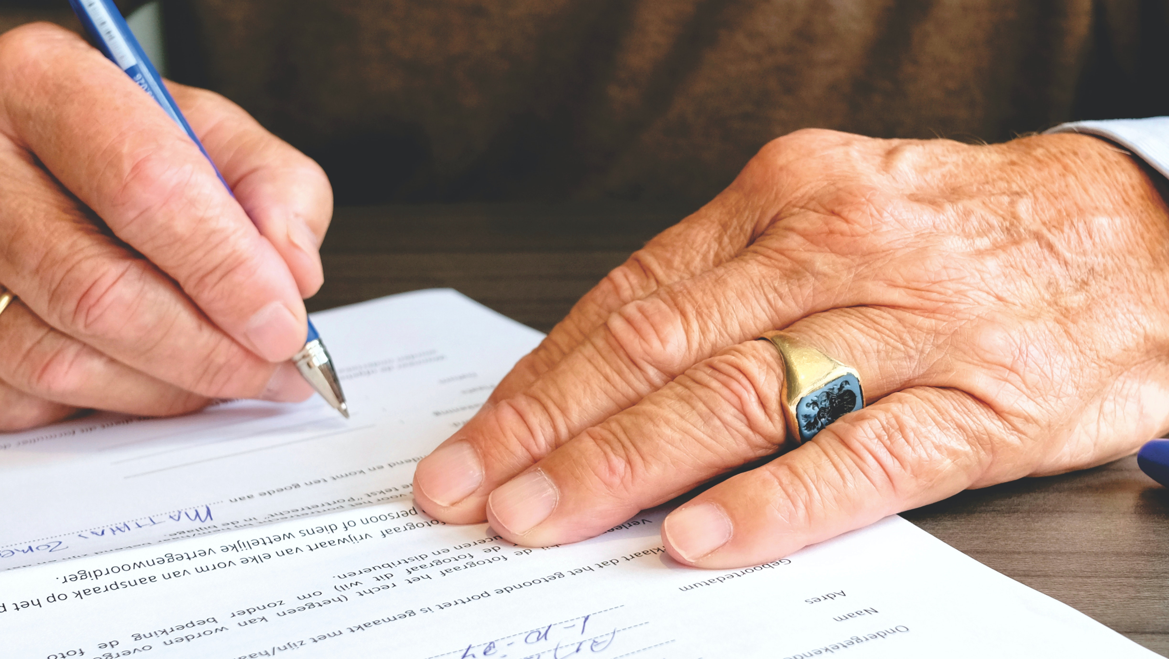 Aged person siging an english legal document translation