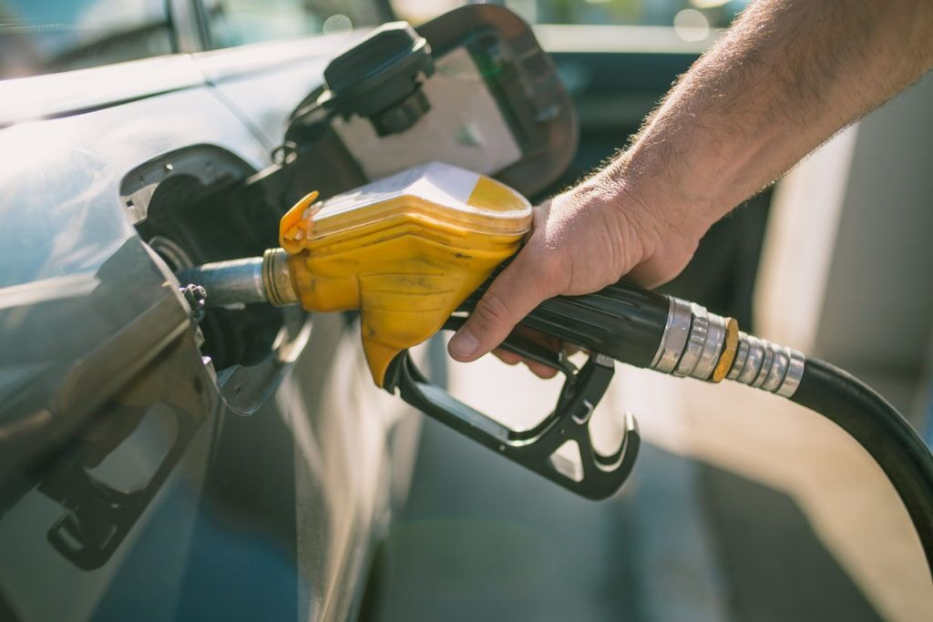 Person pumping gas on their car