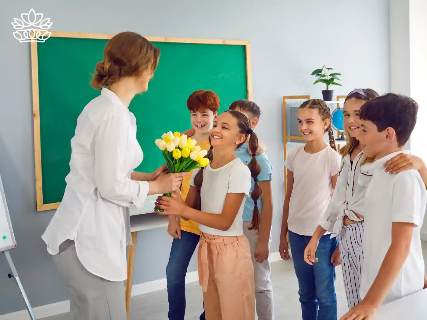 Teacher receiving yellow tulips on Teacher's Day from smiling students in a classroom, expressing appreciation and joy. Teachers & Educators Flowers. Delivered with Heart. Fabulous Flowers and Gifts.