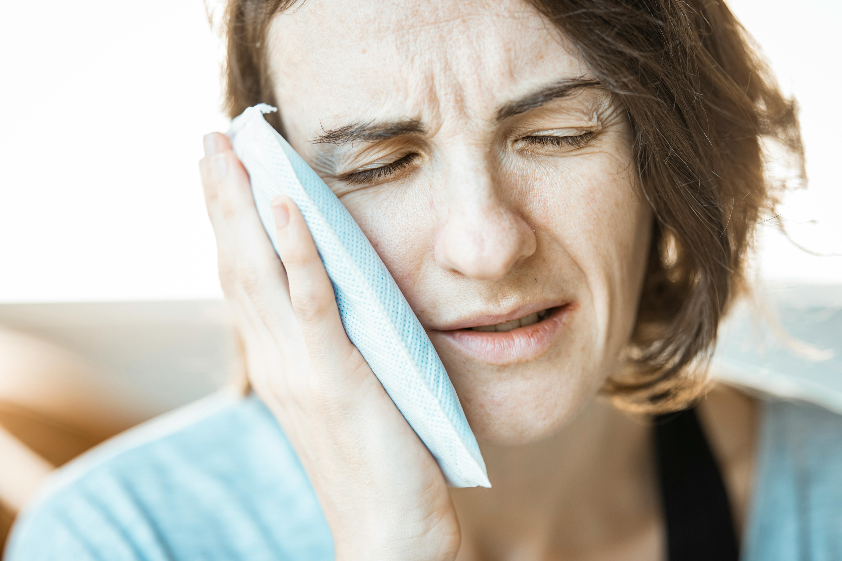 woman experiencing tooth pain possibly from cracked tooth