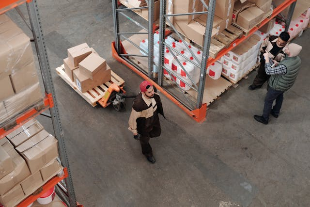 Staff walking through an warehouse. With EMDECS as a cloud service fleet maintenance software, you can access your inventory reports and protect your fleet assets by having a comprehensive truck parts inventory and identify parts usage anytime and anywhere.