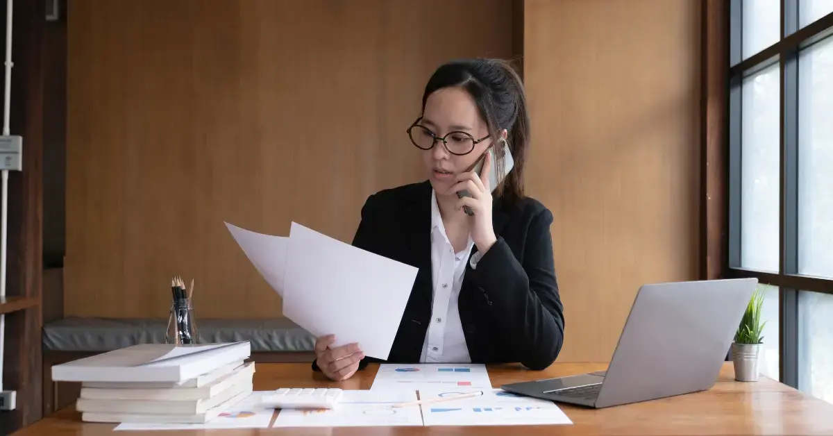 Woman reviewing IRS tax lien and mortgage papers for lien subordination.