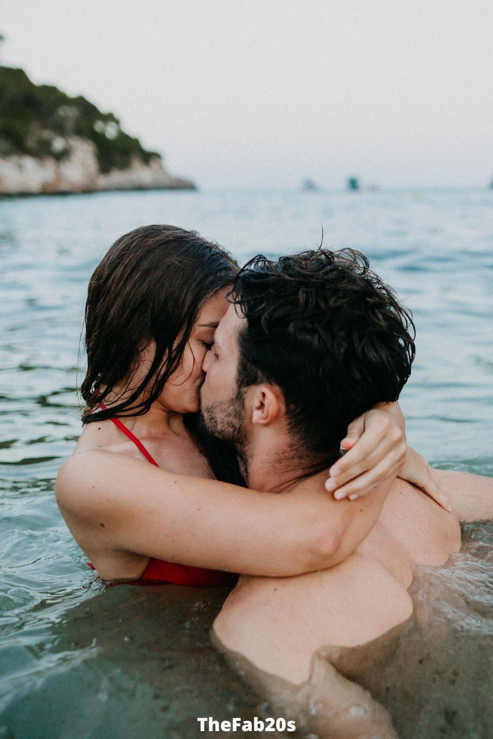 Couple kissing romantically in the ocean - Featured in: How to stop overthinking in a relationship