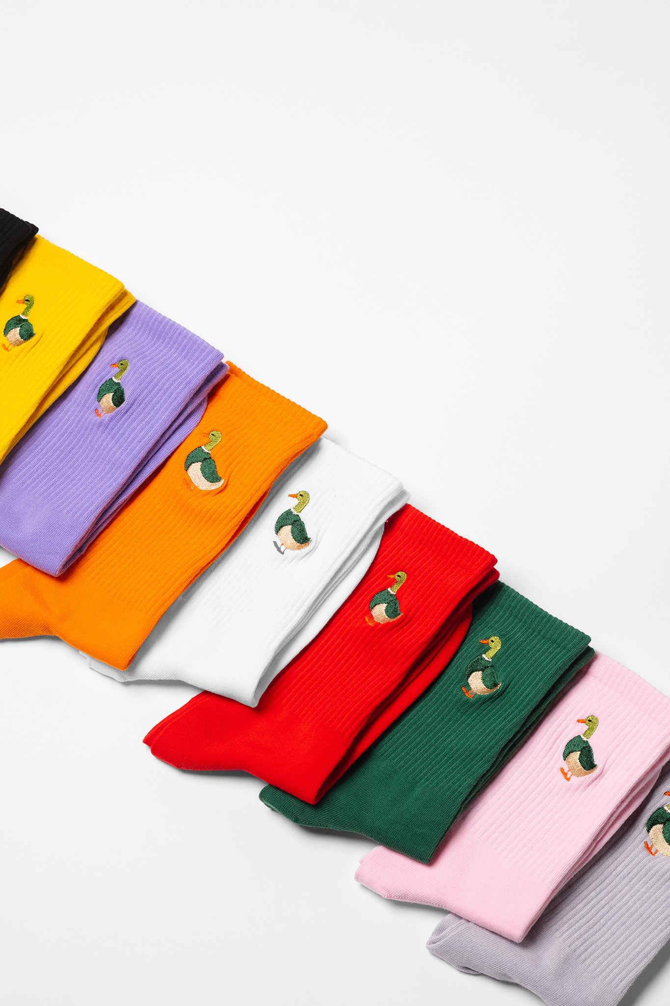 A colourful collection of mens crew socks with a duck embroidered on each sock of the pair.