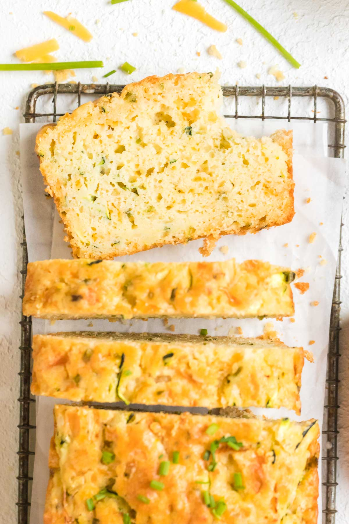 slices of zucchini cheddar bread sliced on cooling rack