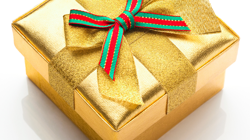 a golded gift box with a bow
