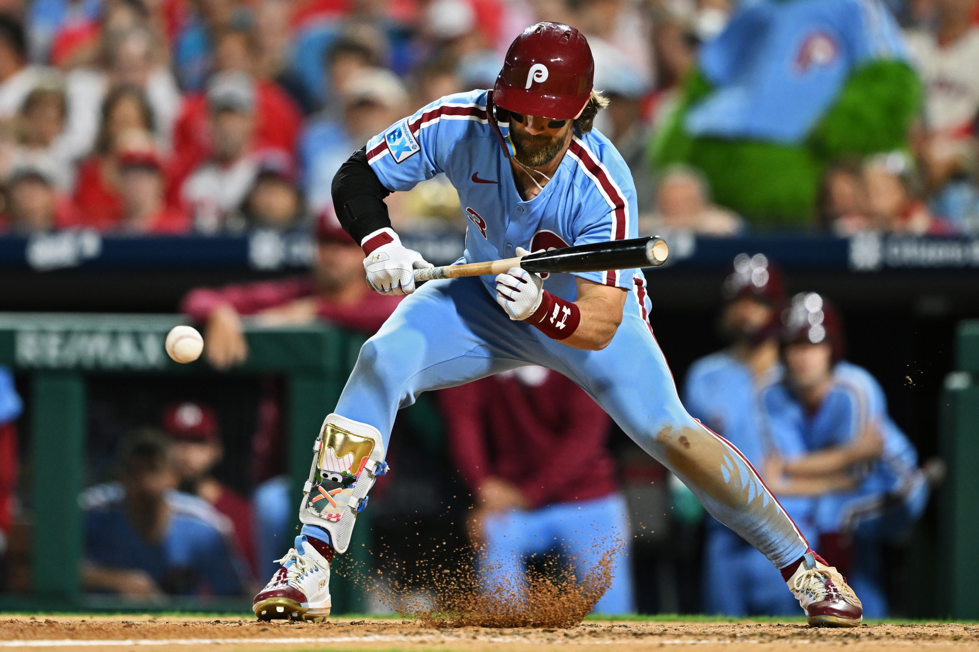 Bryce Harper of the Philadelphia Phillies lays down a sacrifice bunt against the Atlanta Braves on August 29, 2024 in Philadelphia, Pennsylvania.