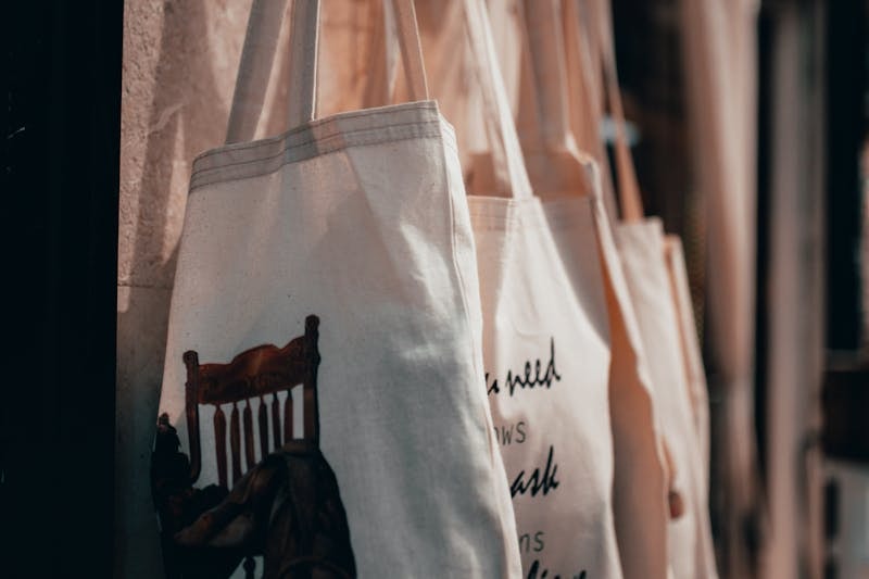 Line of canvas bags hanging on a rack