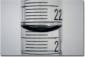 A meniscus of a liquid in a burette, with graduations inscribed