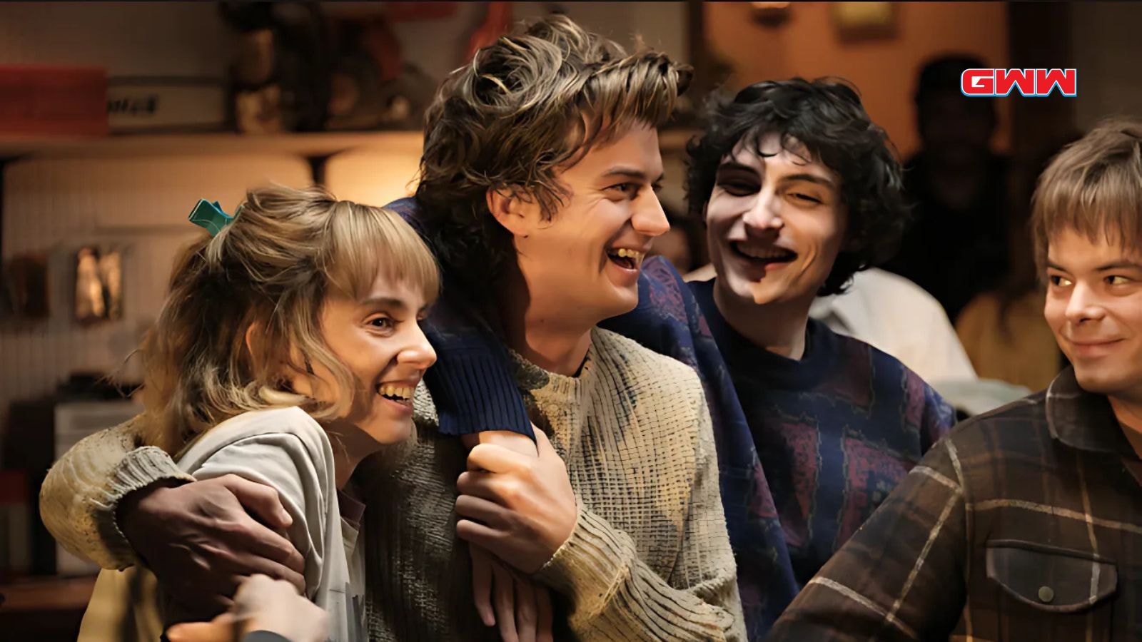 Joe Keery as Steve Harrington, Maya Hawke as Robin Buckley, Finn Wolfhard as Mike Wheeler, and Charlie Heaton as Jonathan Byers laughing behind the scenes of Stranger Things season 5