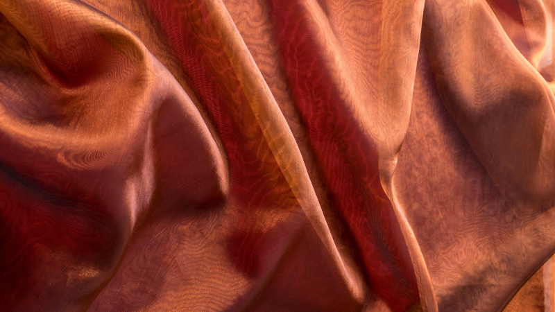 A close-up shot of a red and brown voile fabric