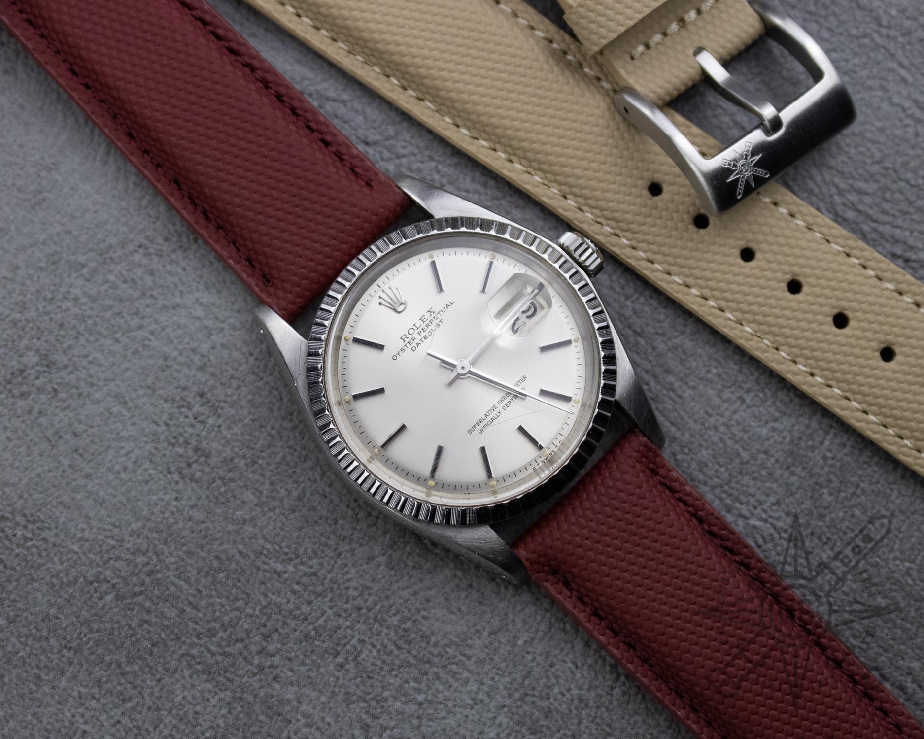 A Tudor watch paired with a red sailcloth strap, highlighting their perfect match.