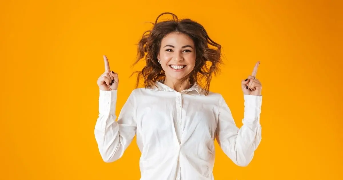 Happy OnlyFans creator celebrating success while understanding freelancing and taxes in a bright setting.