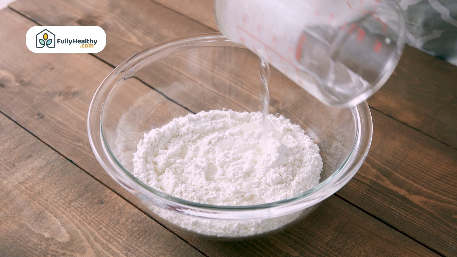 Cornstarch powder in ceramic bowl with spoon on burlap cloth