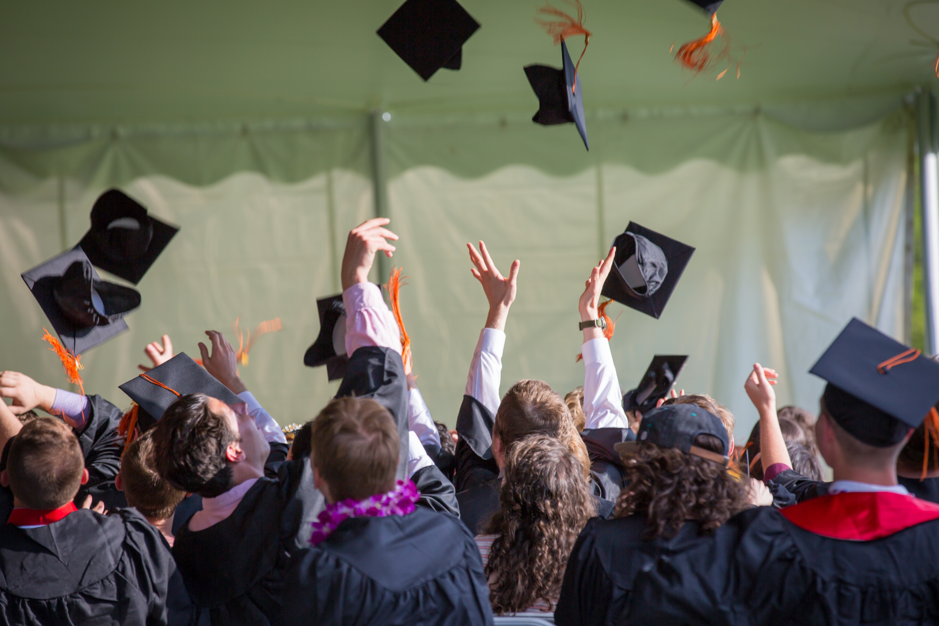 Students tossing their graduation hats.