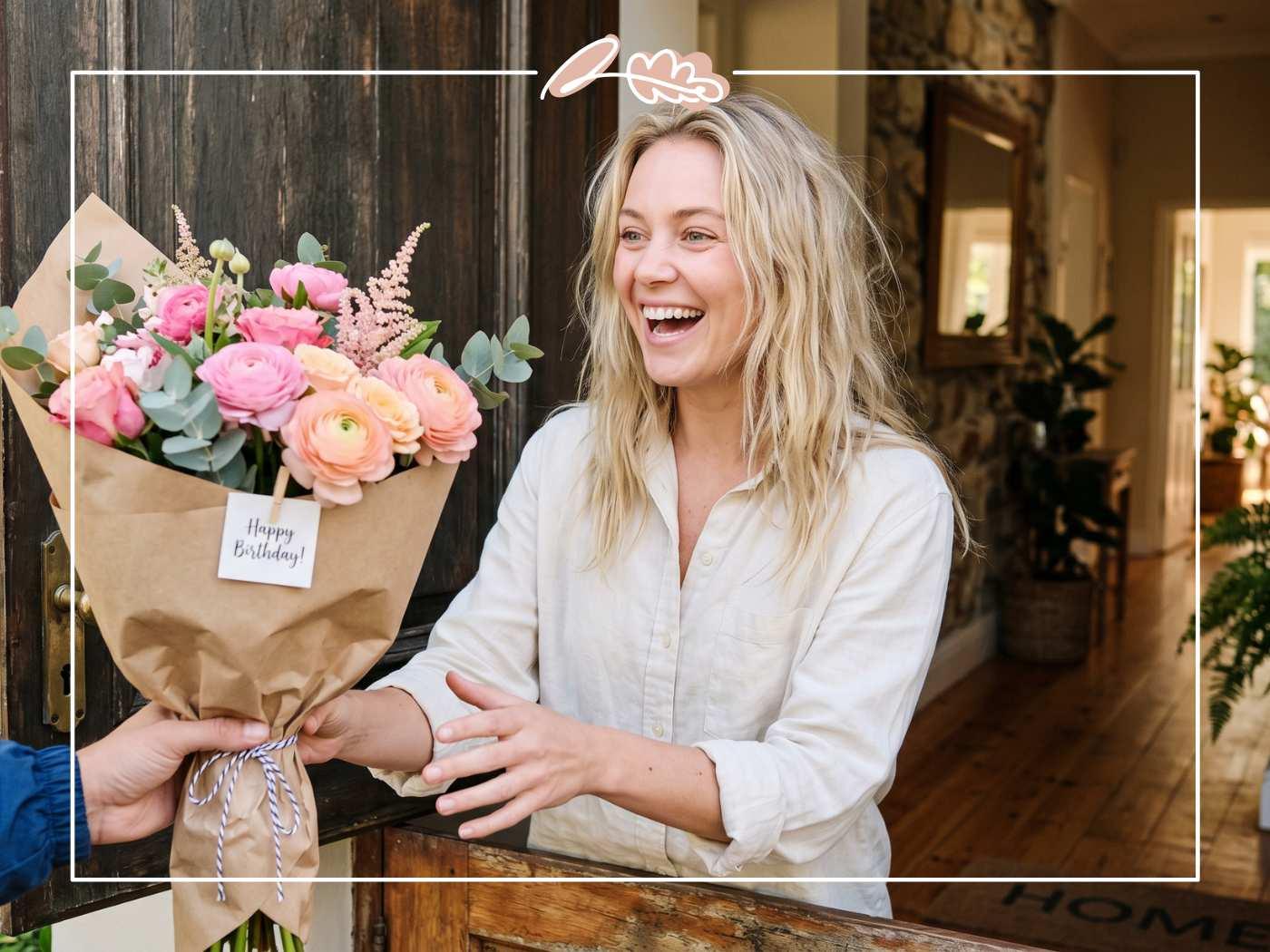 Joyful woman receiving a same-day birthday flower delivery of pink roses and ranunculus from Fabulous Flowers at her front door