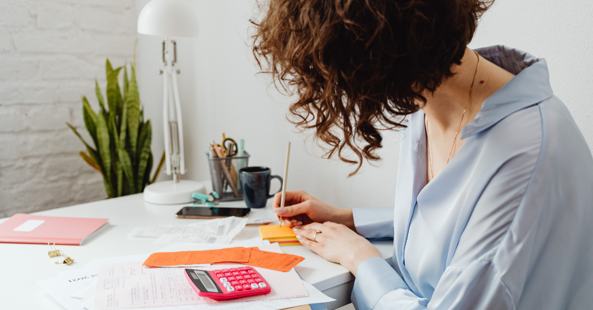 OnlyFans creator calculating accumulated depreciation and reviewing tax forms to optimize her deductions.