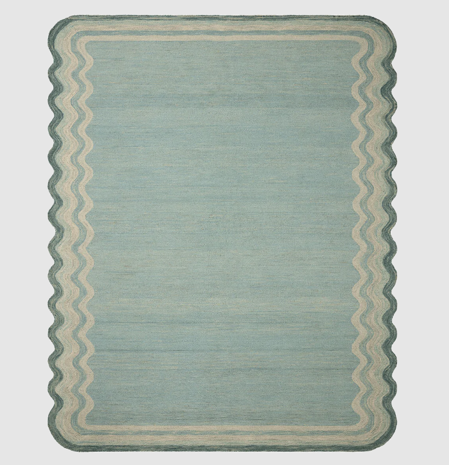 Blue-green rug with wavey border on the lengths