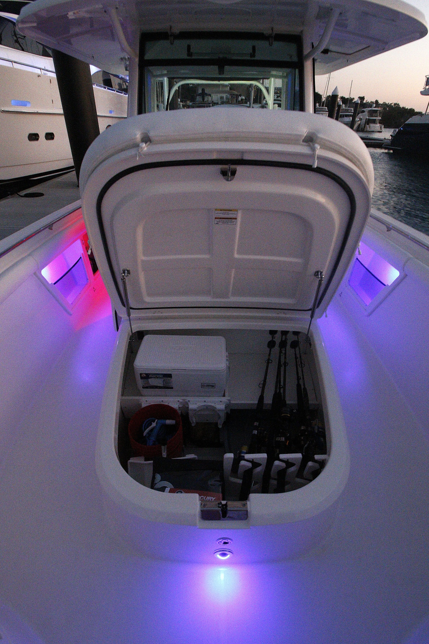 The Boston Whaler 350 Outrage center console features a large storage cabinet under the flip up padded lounger