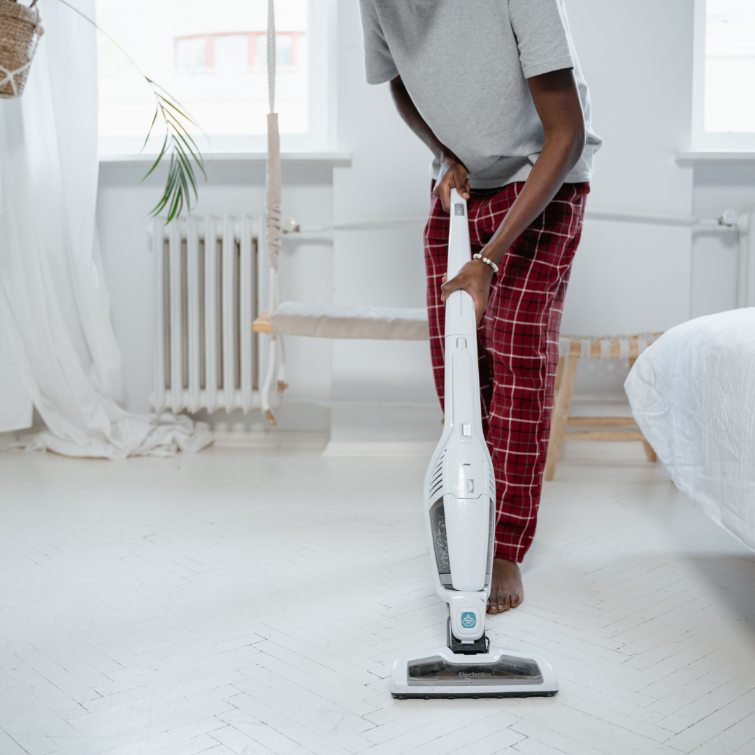 man vacuuming his floor