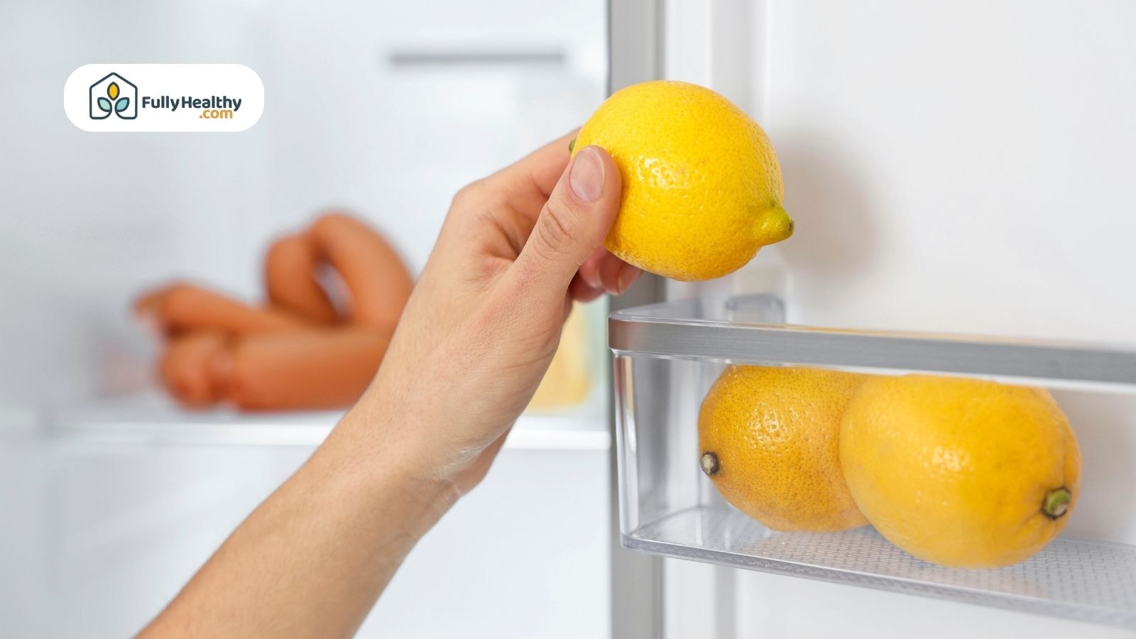 Hand placing a lemon into fridge door next to others