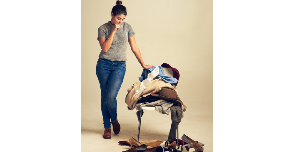woman choosing in a piled of clothing