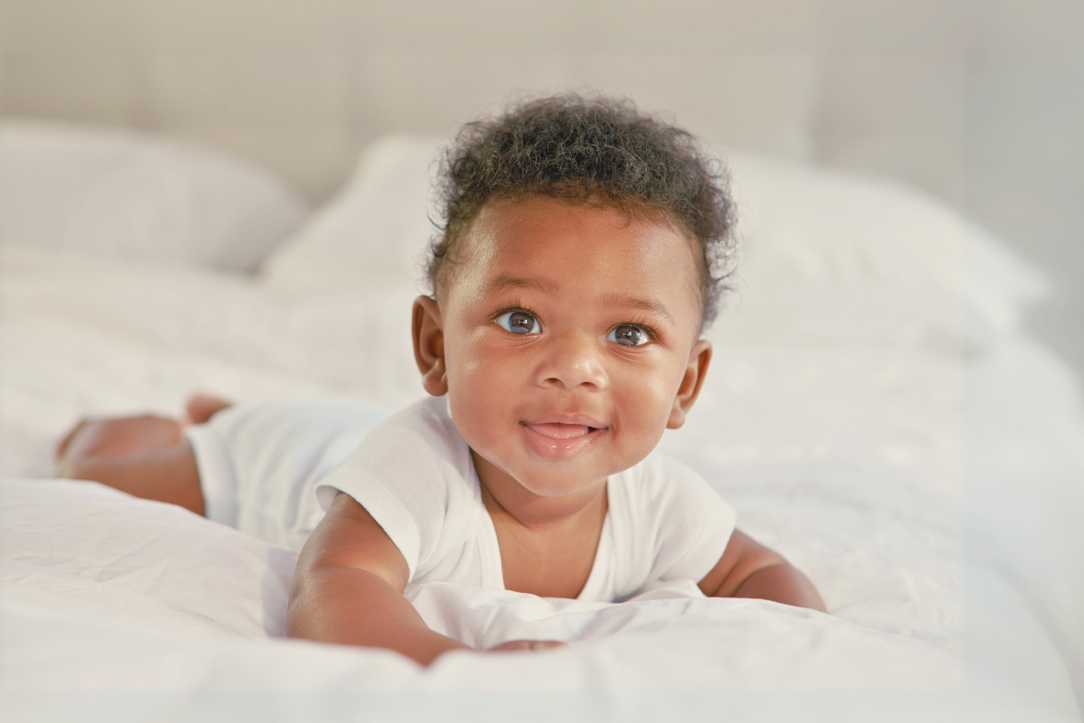 Infant lifting up head Poppyseed Play