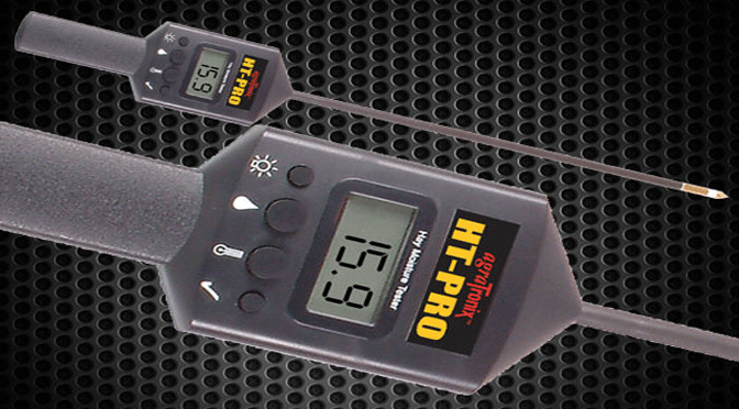 A hay moisture tester with an illuminated LCD display