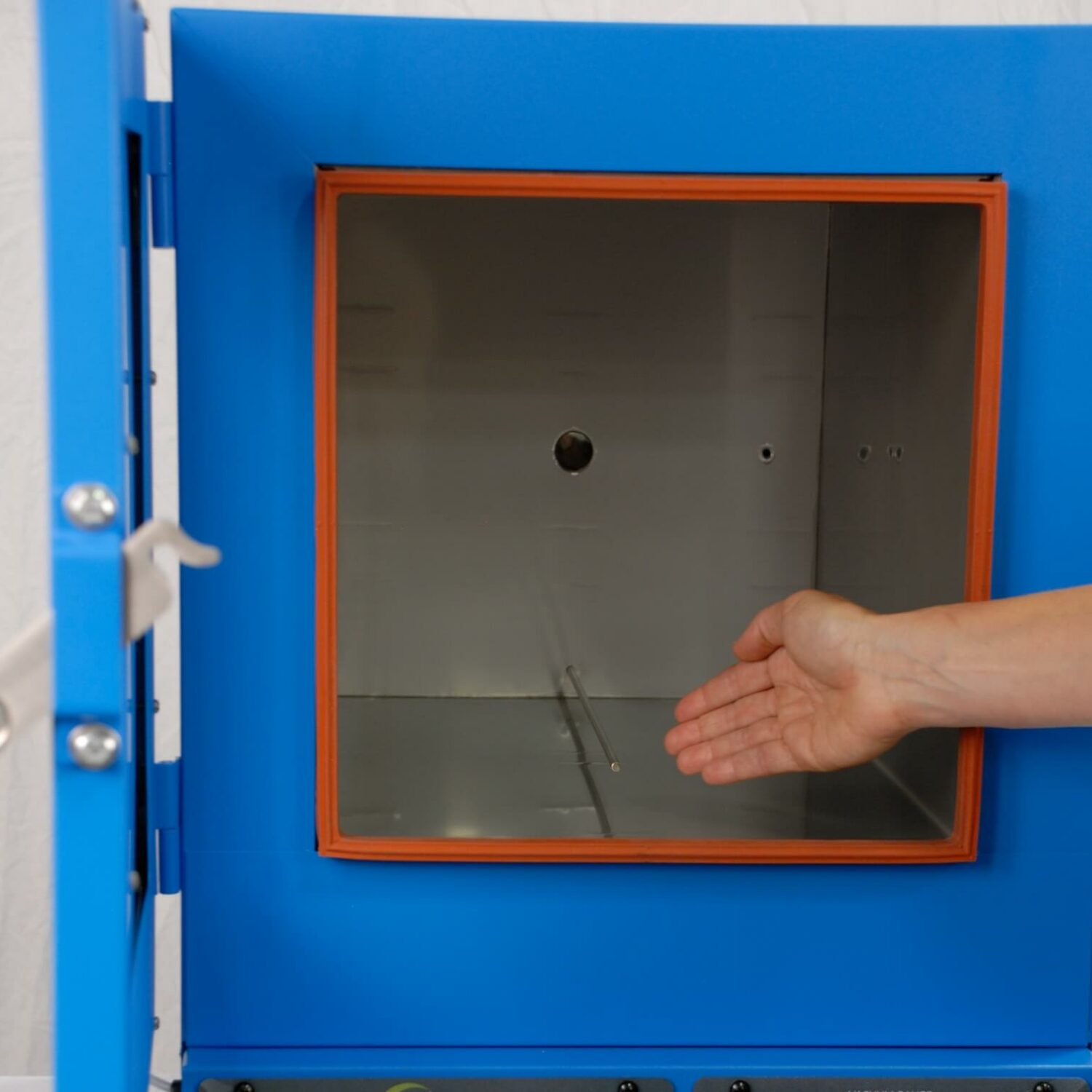 A person aligning a new gasket on an oven door