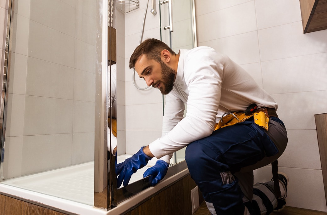 A professional installing a new shower during the installation process.