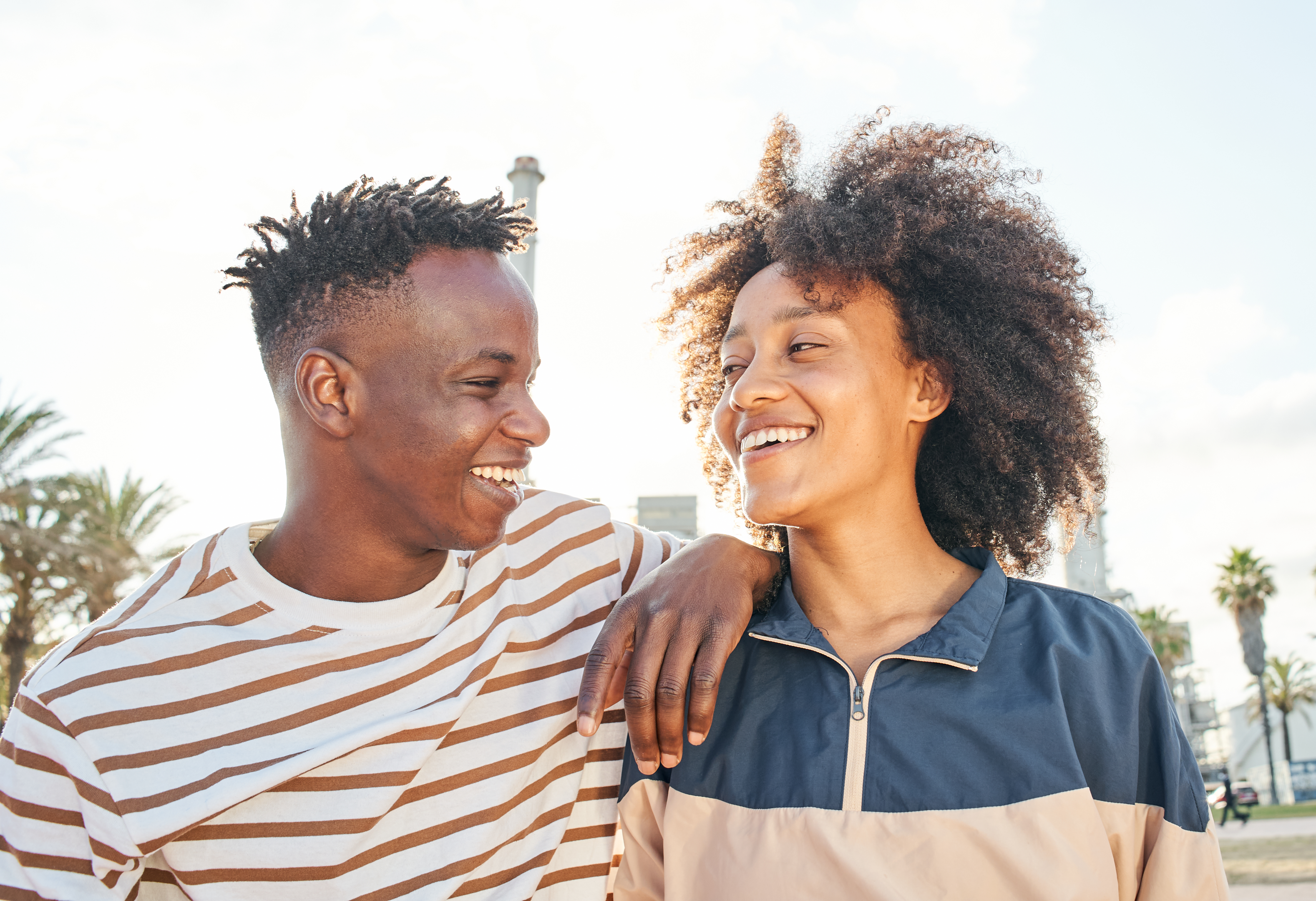 ouple from New York embracing outdoors, thoughtfully considering strategies to support the partner with adult ADHD, nurturing their relationship through empathy and understanding.