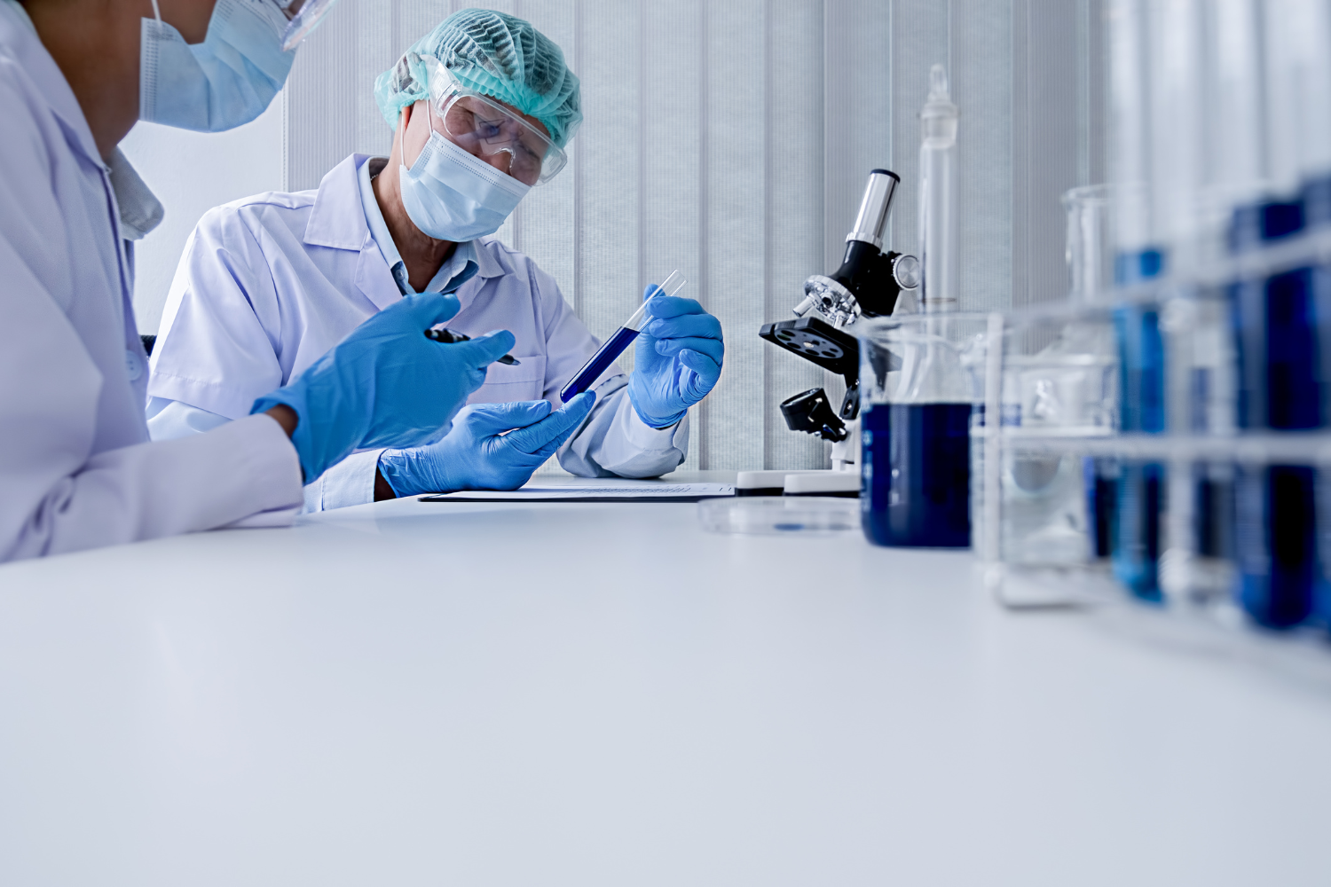 A researcher in a lab using test tubes, charts, and data to validate supplement trends.