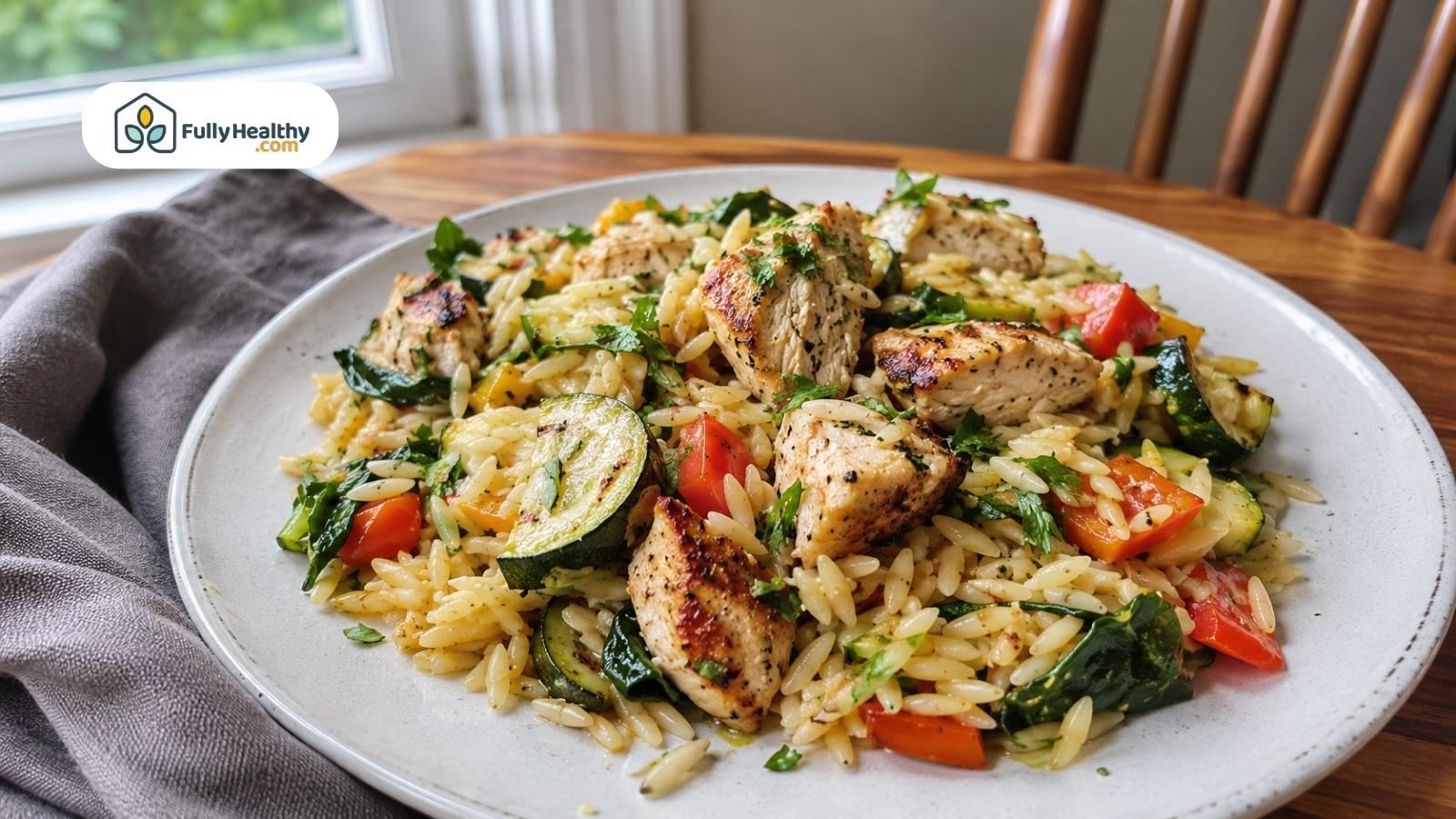 Grilled chicken orzo with zucchini tomatoes spinach and fresh herbs