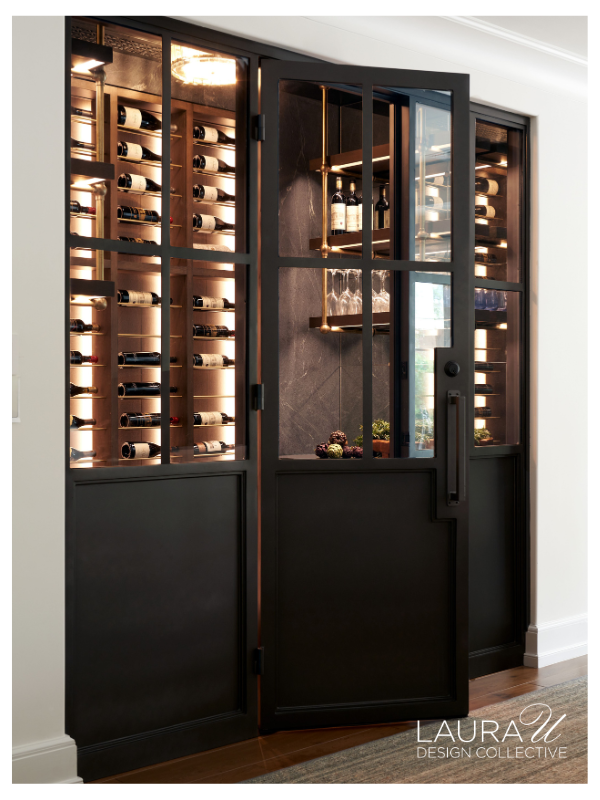 Steel and glass wine cellar doors revealing illuminated custom wine storage behind.