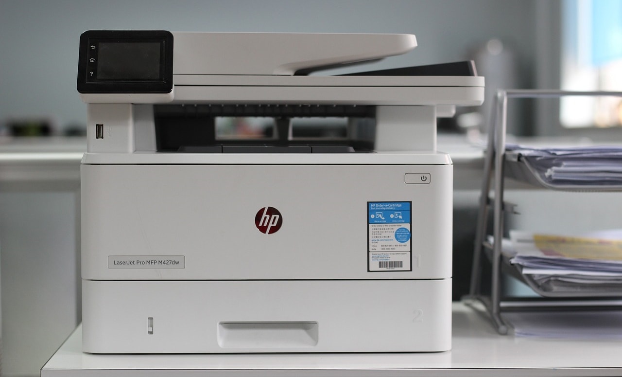 HP LaserJet Pro MFP M28w printer on a desk